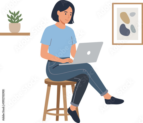 Woman sits on stool working on laptop indoors at home