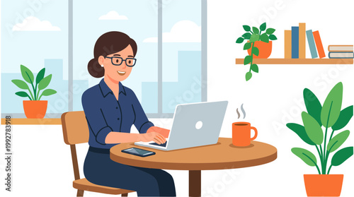 A woman works on her laptop at a table by the window in an office setting.