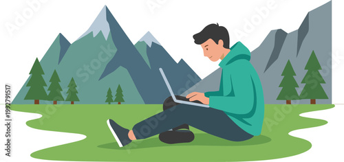 A man works on laptop sitting on green grass in front of mountains.