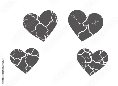 Four cracked grey hearts with white fissures a white broken