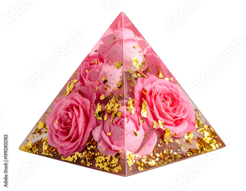 A pyramidal decorative item filled with vibrant pink roses and golden flakes, encased in a transparent material