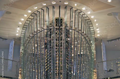 Futuristic modern Art Deco interior design style furniture, carpets and paneling onboard luxury cruiseship liner cruise ship main dining room restaurant with columns and chrome chandelier