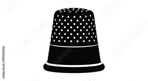 A black and white image of a vintage thimble detailed with dots silhouette