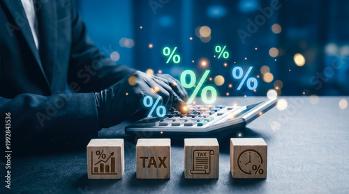 Businessman using calculator for tax calculation and financial planning with percentage icons and wooden blocks