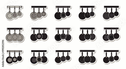 Set of various sized hanging cooking pans, pots, and skillets, kitchenware, cooking utensils, culinary tools, isolated on white background