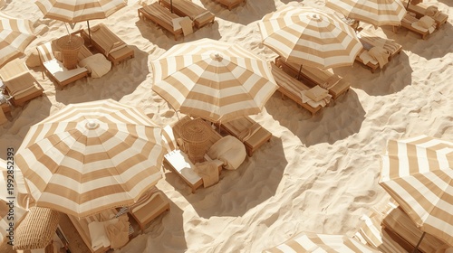 Striped beach umbrellas and lounge chairs on the sand at the coast