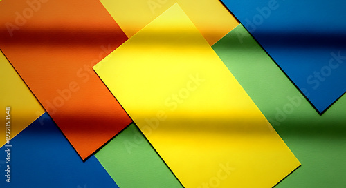 Vibrant color blocked textured paper background with orange yellow blue and green sheets