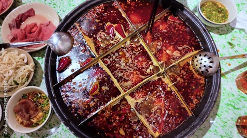 Tourists eating the original spicy dish mala spicy hot pot in Chengdu, China
