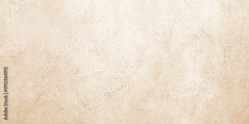 A blank vintage parchment with a stained grunge texture and aged beige surface rests on a rough antique wood wall to create a retro paper design