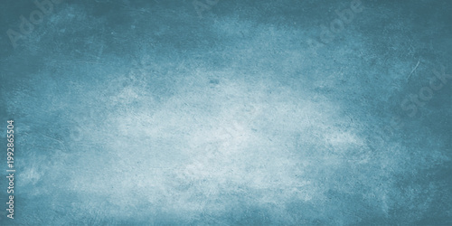 Aged blue grunge wall texture with a dark vintage paint pattern and rough paper material design creates a weathered retro art backdrop