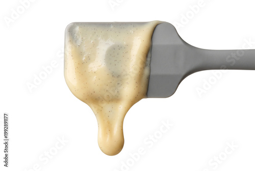 batter dripping from a gray silicone spatula