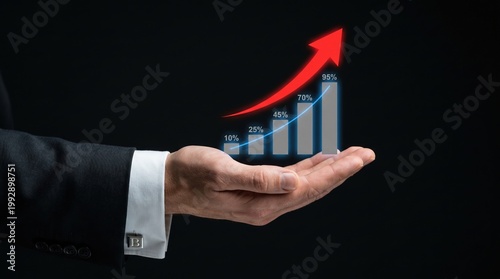 Businessman holding holographic bar graph with rising arrow indicating growth in dark studio setting