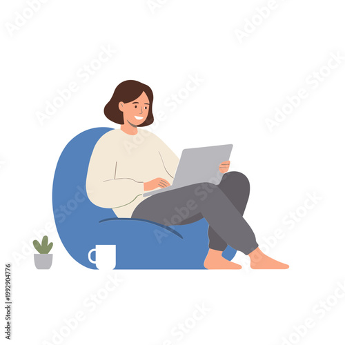 A woman sits comfortably on a blue beanbag chair with a laptop.