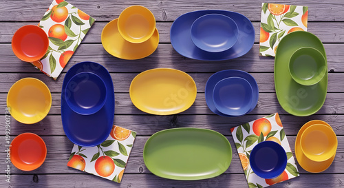 Colorful ceramic bowls and plates laid out on a wooden surface