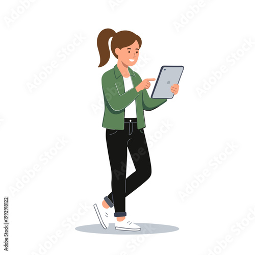 Woman standing and smiling while using a tablet indoors with casual clothes