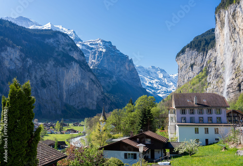 Amazing view of the picturesque alpine town of Lauterbrunnen, Switzerland. The village church and the Staubbach Falls in Lauterbrunnen