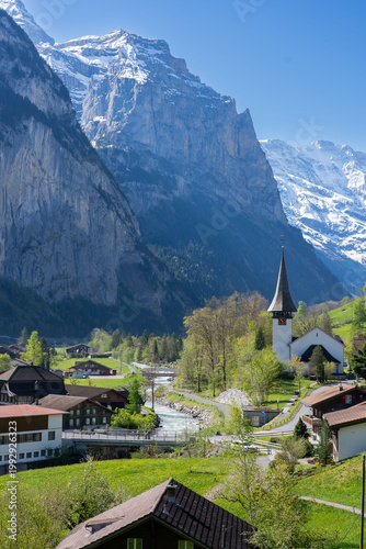 Amazing view of the picturesque alpine town of Lauterbrunnen, Switzerland. The village church and the Staubbach Falls in Lauterbrunnen