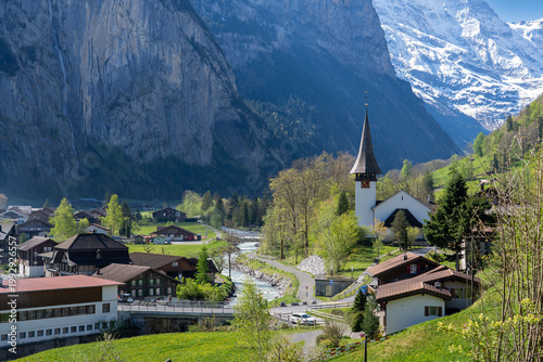 Amazing view of the picturesque alpine town of Lauterbrunnen, Switzerland. The village church and the Staubbach Falls in Lauterbrunnen