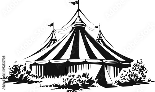 Large striped circus tent with flagpoles surrounded by bushes and foliage