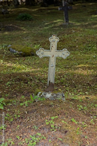 Old, weathered cast-iron grave cross in an old cemetery, Muhu, Estonia, Europe.