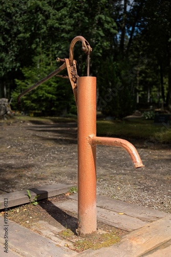 Manual hand-operated water pump, typically used to draw water from a well, Muhu, Estonia, Europe.