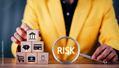 Risk management concept with magnifying glass and wooden blocks.