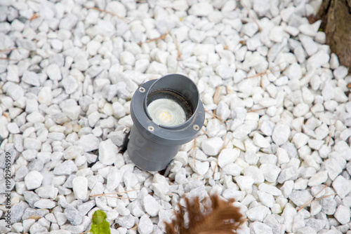 Flashlight on the white pebbles in the garden, stock photo