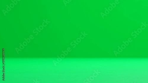 Vibrant Green Sphere Rolling Across a Monochromatic Studio Background.