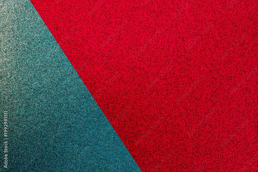 Fototapeta premium Colorful texture reveals a mix of red and teal surfaces with a smooth finish creating an interesting visual display
