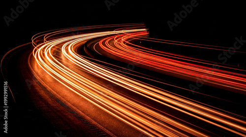 Valokuva Long exposure photograph capturing bright car light trails on a curved highway
