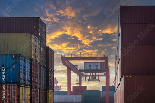 Container Terminal at Sunset with Gantry Crane and Stacked Freight Boxes