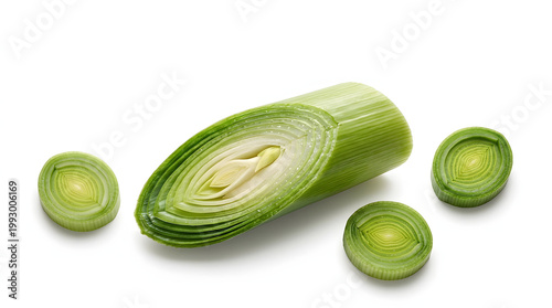 A halved leek showing stunning concentric ring layers with round cross-section slices on white.