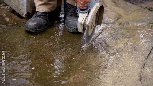 Construction worker cutting concrete with a circular saw