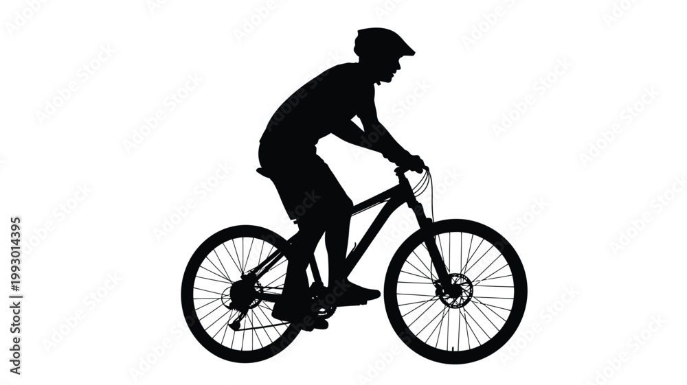 Obraz premium A cyclist riding a mountain bike in a dark striking silhouette