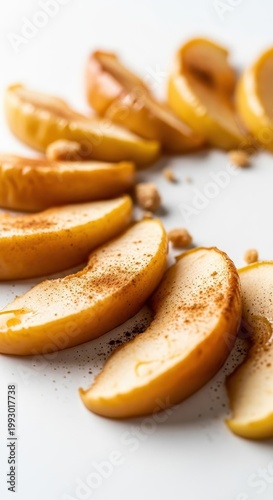 Delicious Baked Apple Slices with Cinnamon on White Surface.