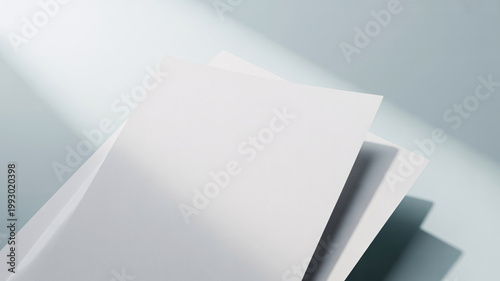 A stack of white papers with a beam of light shining on them