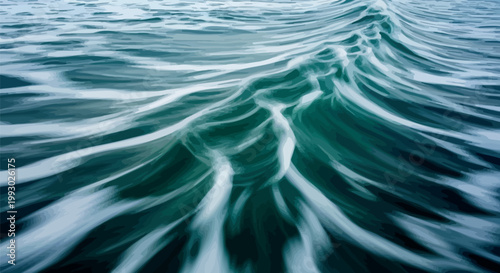 Long exposure photography captures the silky smooth movement of deep turquoise ocean waves flowing continuously across the surface in a beautiful and calming aquatic pattern