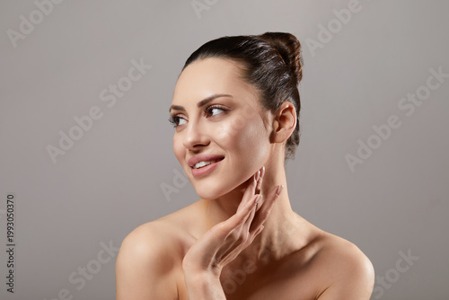 Fotografie Beautiful woman beauty portrait looking aside touching neck and jawline, female