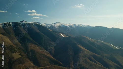 Sunny Mountain Scenery. Bright Sunlight Illuminates Serene Mountain Ridges And Peaceful Valleys With Warmth