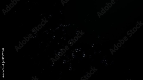 Small Transparent Spheres and Bubbles Floating Over Deep Black Background Minimalist Concept