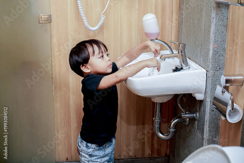 Little Kid Playing With Water Stream While Washing Hands