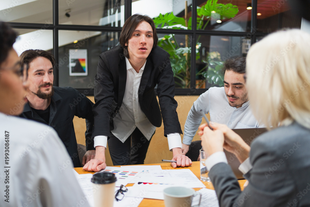 Fototapeta premium Teamwork brainstorm. Coworkers cooperating working together at office meeting. Colleagues discussing project ideas. Group of people in creative office discussing business. Young professional team
