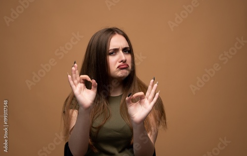 Quadro su tela Woman making sarcastic ok gesture with frowning face, expressing disapproval and