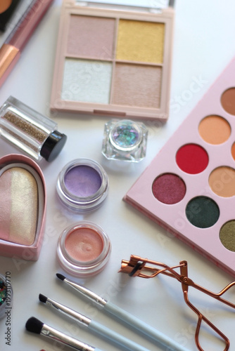 Various colorful cosmetic products on white background. Selective focus.