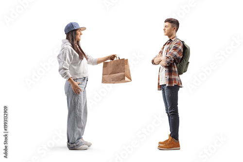 Girl giving a paper bag to a male student