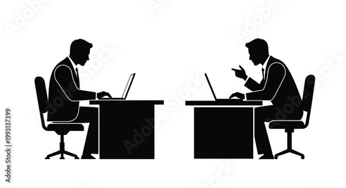 Two businessmen having a discussion while working on laptops at desks