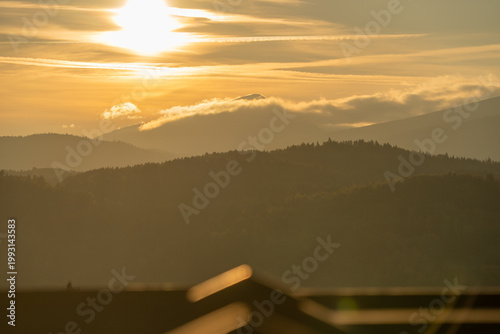 The peak of Babia Gora in the clouds just before sunset.
