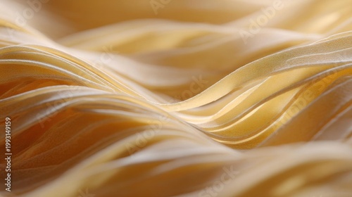 Close-up of a fabric with a wavy pattern. the fabric appears to be a light yellow color and has a smooth texture. the lines on the fabric are thin and wavy, creating a sense of movement and depth.