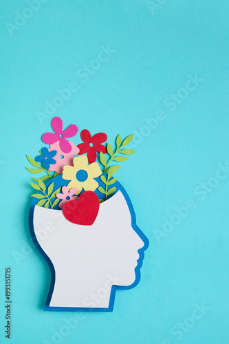 Mental health concept featuring a head silhouette and a flowers blooming