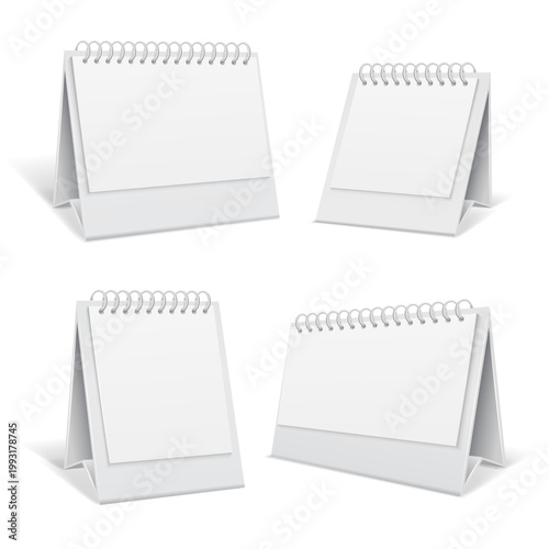 Four blank white desk calendars with spiral binding are arranged in a grid pattern on a clean white background ideal for graphic design mockups